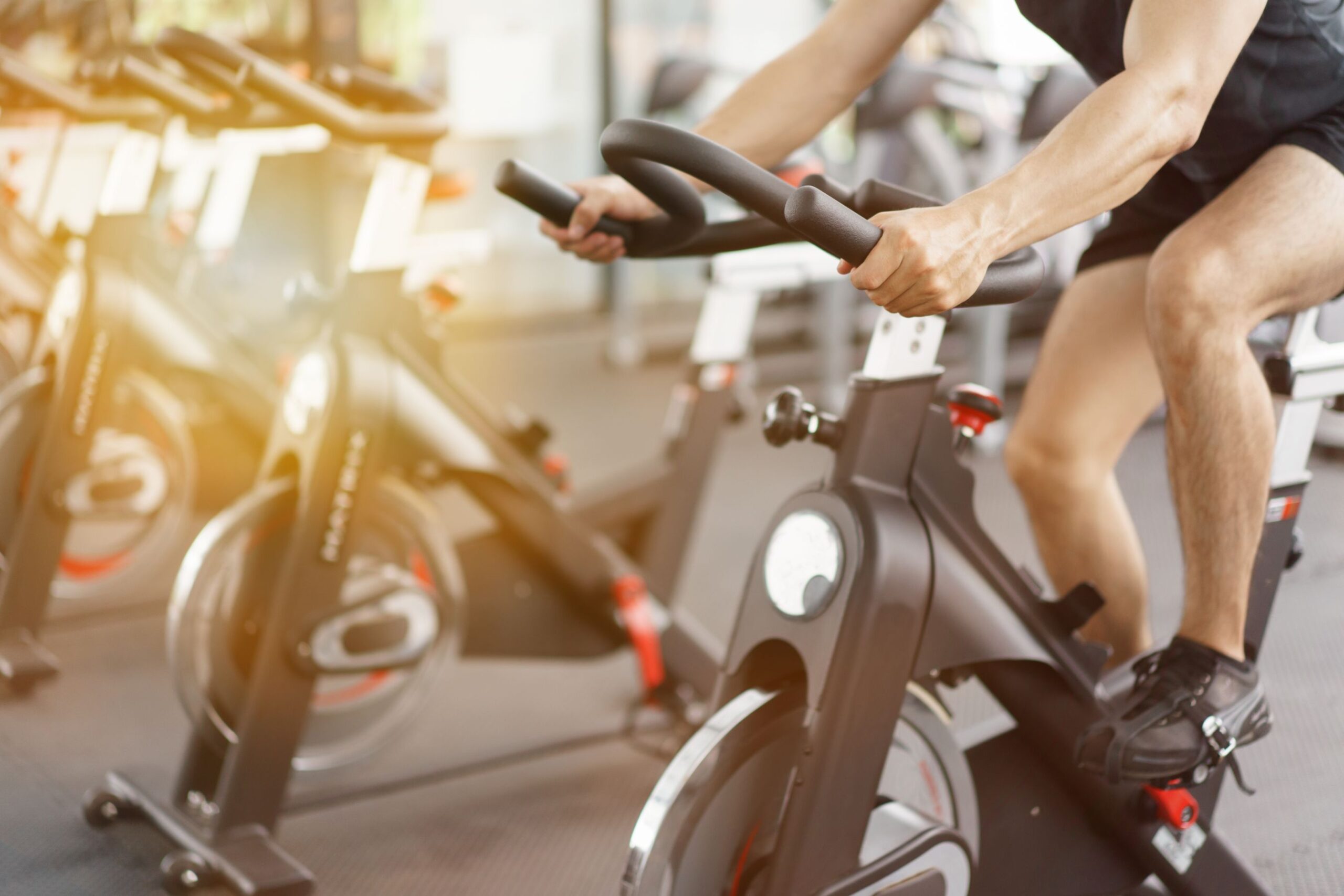 Man cycling on bike in fitness gym